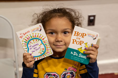  a student holds up their two books