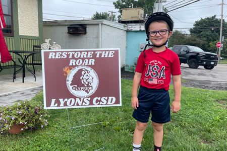  LCSD student with Restore the Roar lawn sign